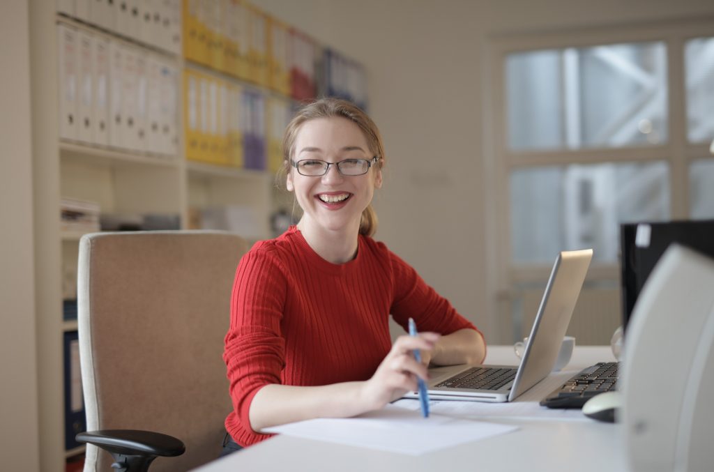 Stock image of a lady smiling at her laptop